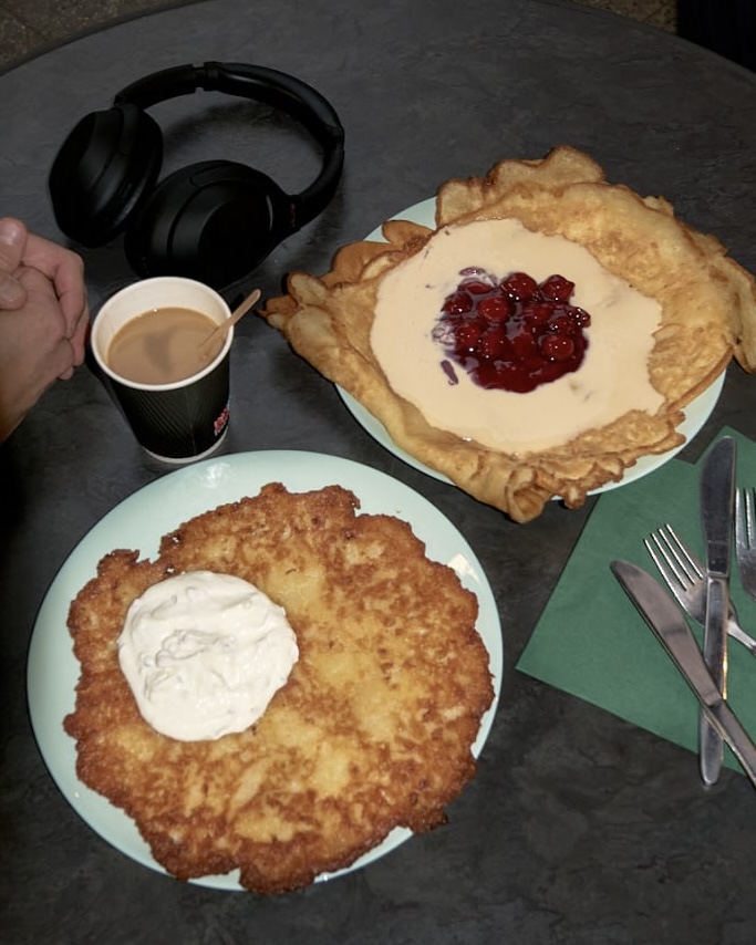 A giant potato pancake with herb sour cream and an Eierkuchen topped with cherries and vanilla cream at Puffer-Imbiss